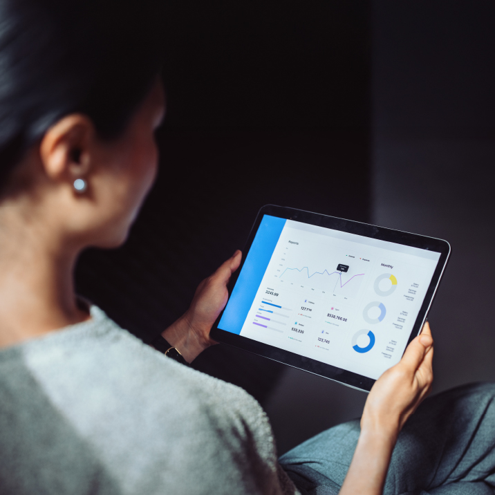 woman looking at ipad screen with data